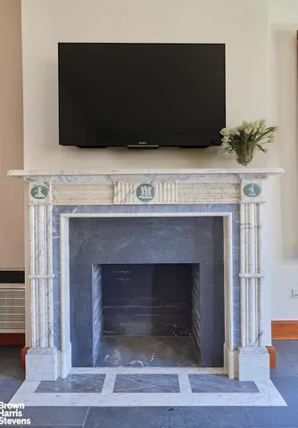 a view of room with window and wooden floor
