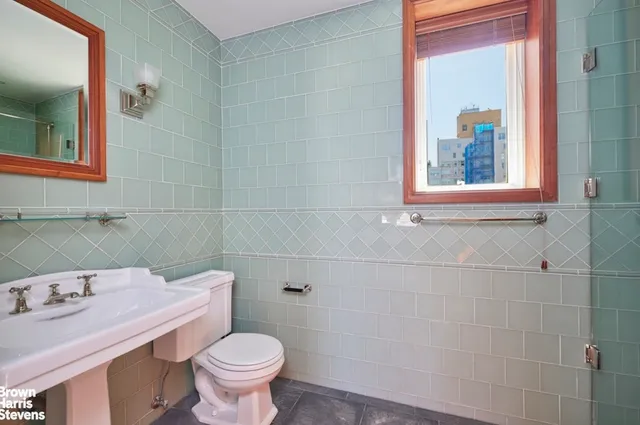 a kitchen with granite countertop a sink and a refrigerator