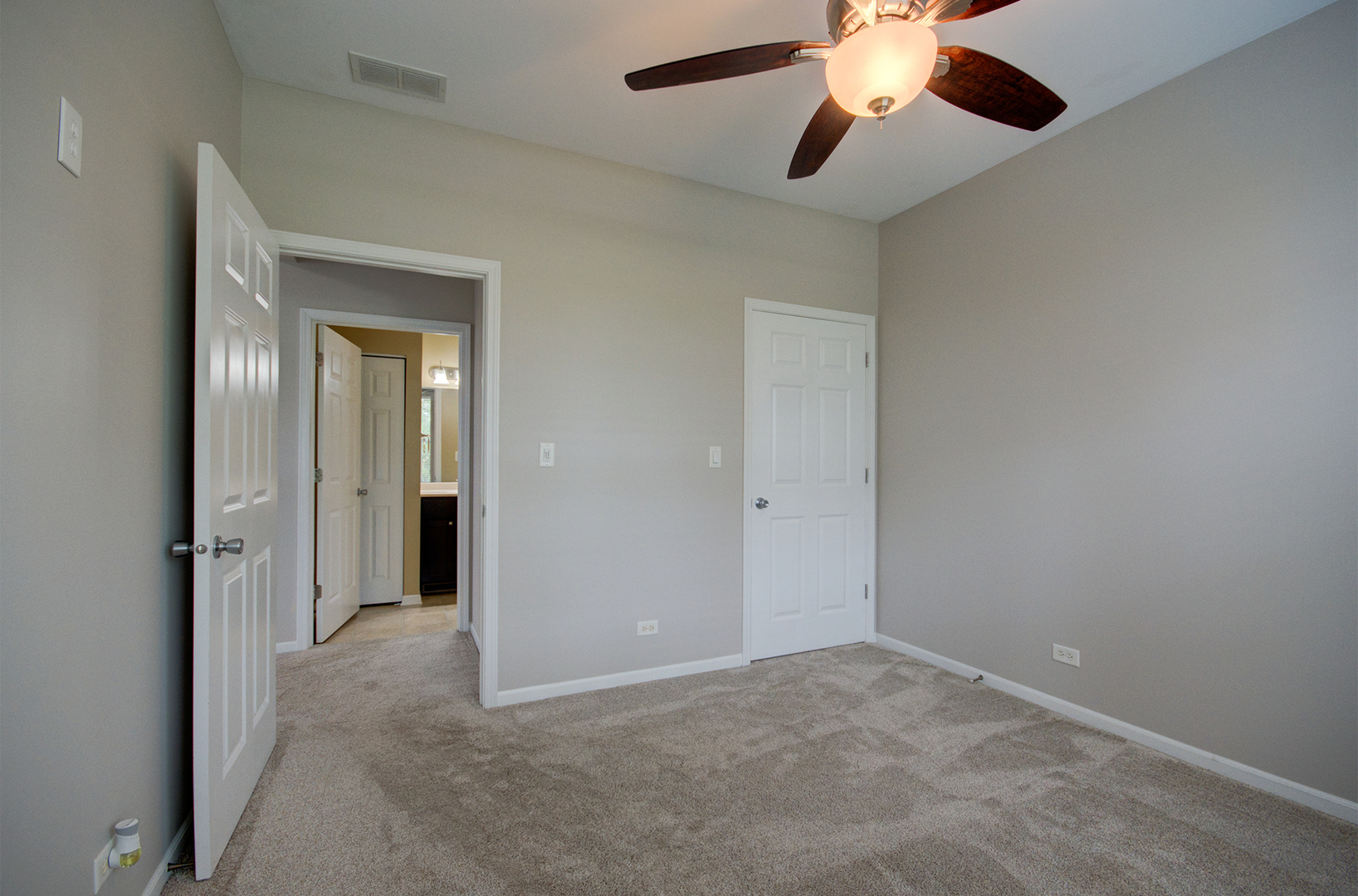 4401 Timber Ridge Court, Unit 4401 Joliet, IL 60431 - Photo 14 of 28 an empty room with chandelier fan and closet area