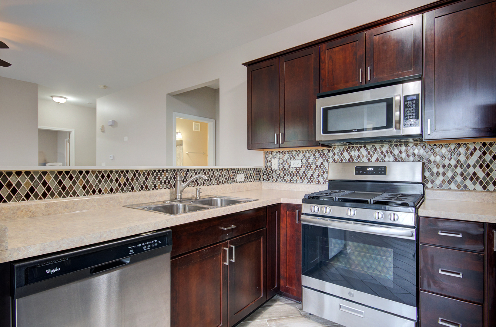 4401 Timber Ridge Court, Unit 4401 Joliet, IL 60431 - Photo 3 of 28 a kitchen with a sink stove and microwave