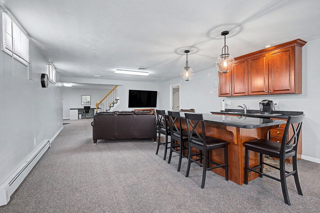 270 Mendon Road Sutton, MA 01590 - Photo 33 of 42 a kitchen with stainless steel appliances kitchen island granite countertop a sink a stove a dining table and chairs