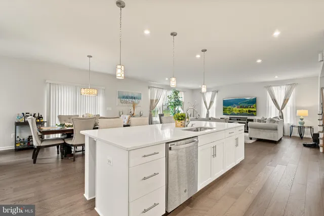 a kitchen with stainless steel appliances granite countertop a sink a stove and cabinets