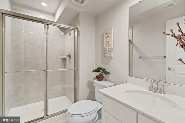 a spacious bathroom with double sink and a mirror