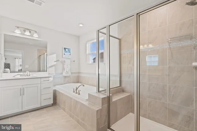 a bath tub sitting next to a white toilet and a shower