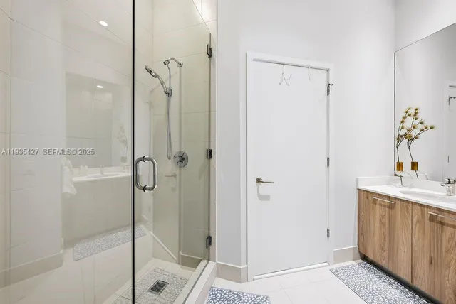 a bathroom with a shower and a sink