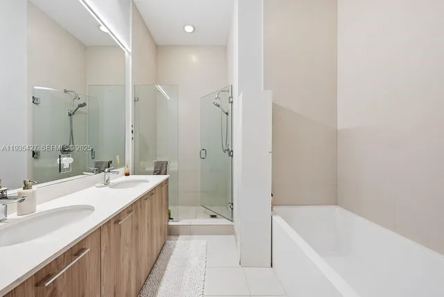 a bathroom with a tub sink and mirror