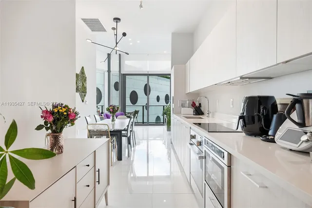 a kitchen that has a lot of cabinets a sink and a stove