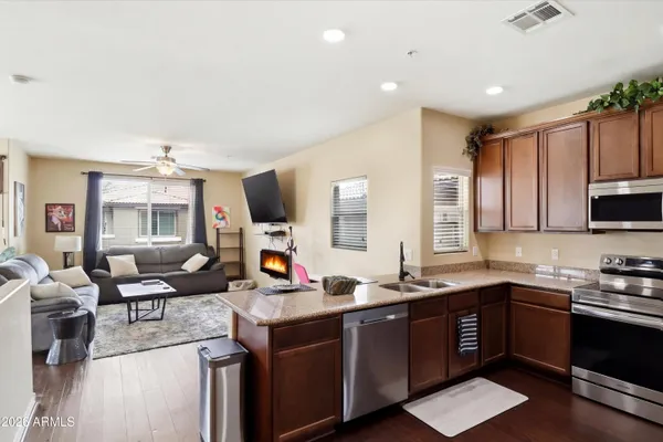 a kitchen with granite countertop a sink cabinets and window
