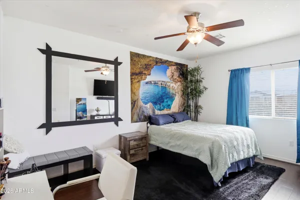 a bedroom with a bed window and couch
