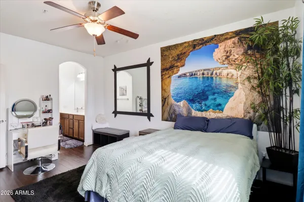 a bedroom with a large bed and a chandelier