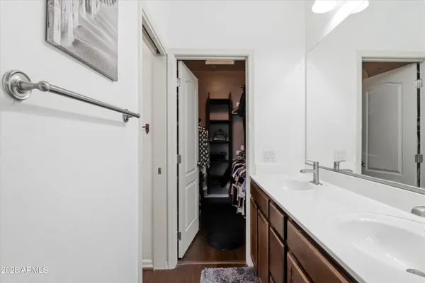 a bathroom with a double vanity sink and a mirror