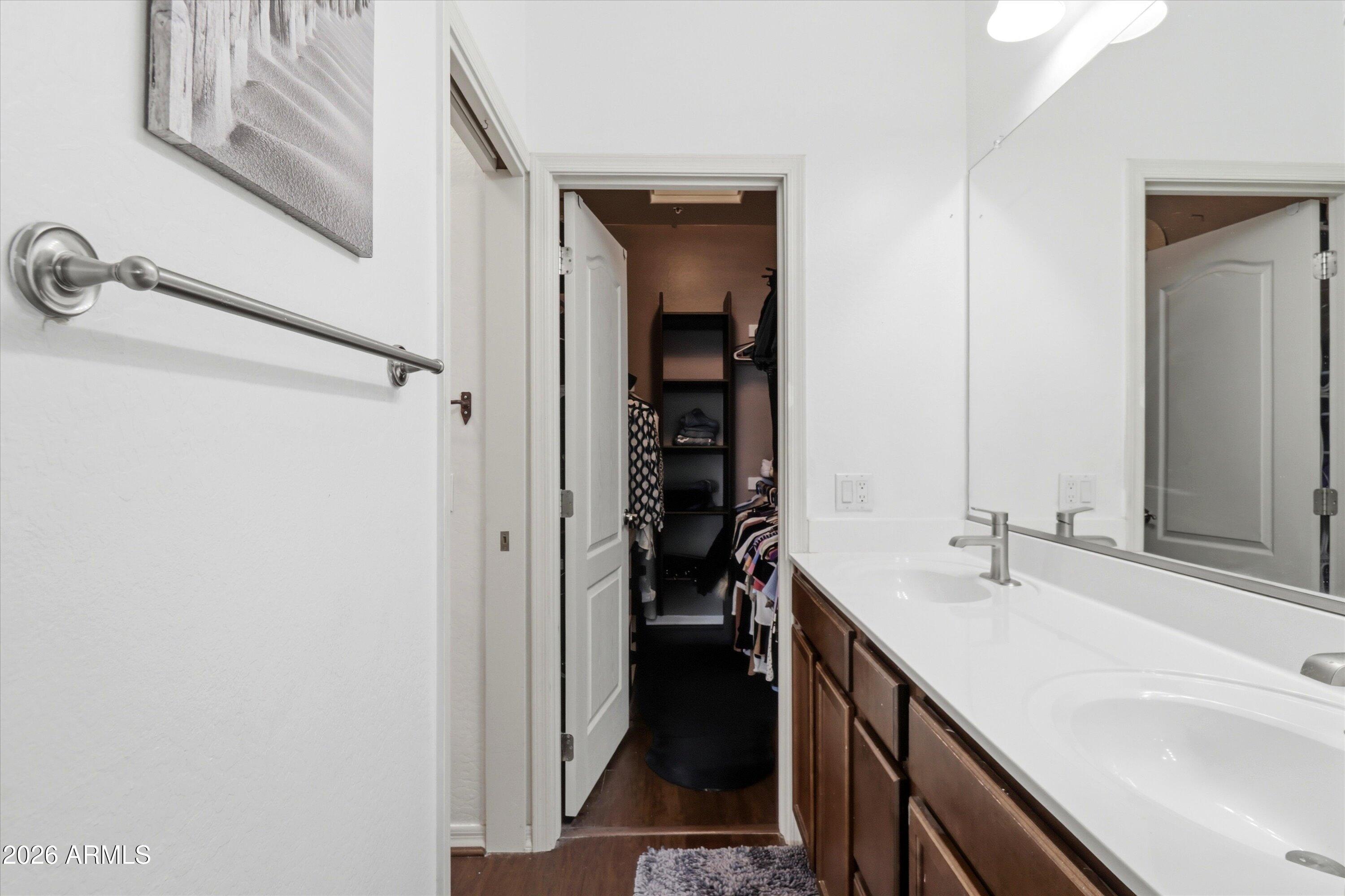 7726 East Baseline Road, Unit 227 Mesa, AZ 85209 - Photo 20 of 22 a bathroom with a double vanity sink and a mirror