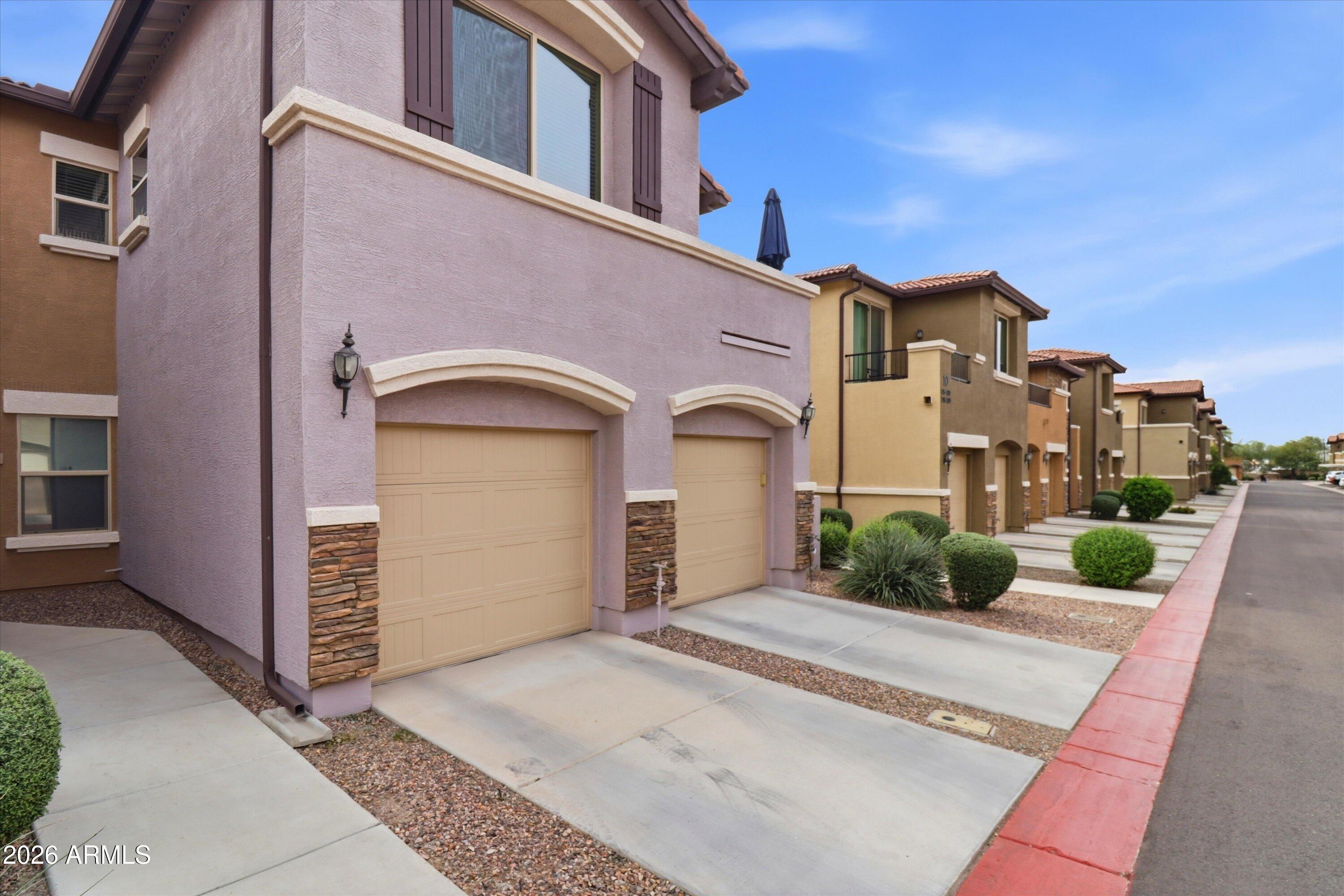 7726 East Baseline Road, Unit 227 Mesa, AZ 85209 - Photo 2 of 22 a front view of a house with a yard