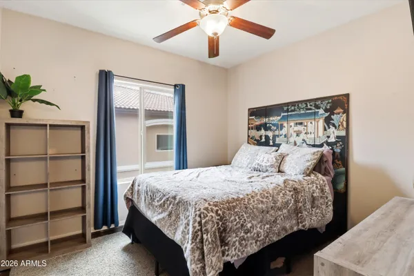 a bedroom with a large bed and a chandelier