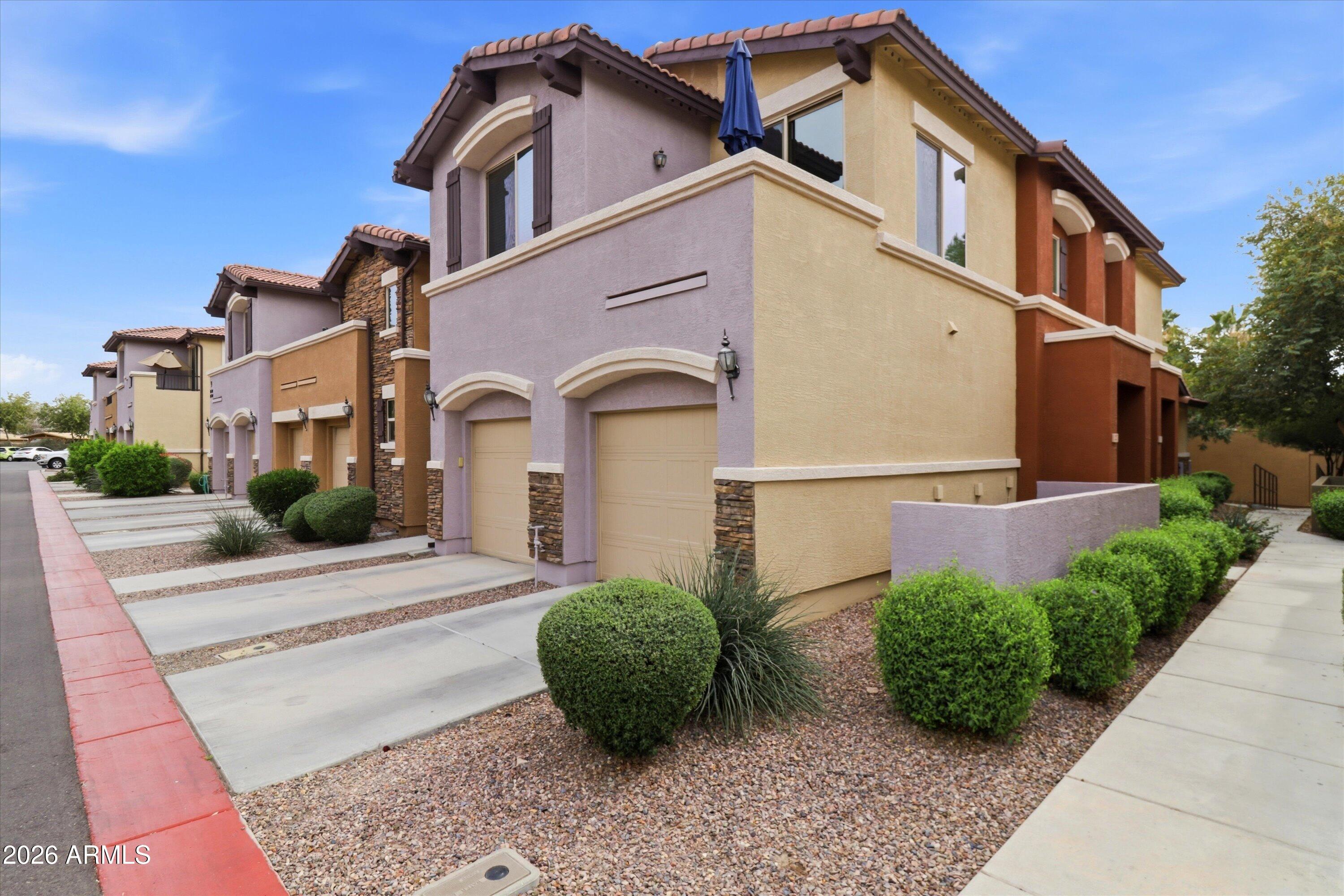 7726 East Baseline Road, Unit 227 Mesa, AZ 85209 - Photo 3 of 22 a front view of a house with garden