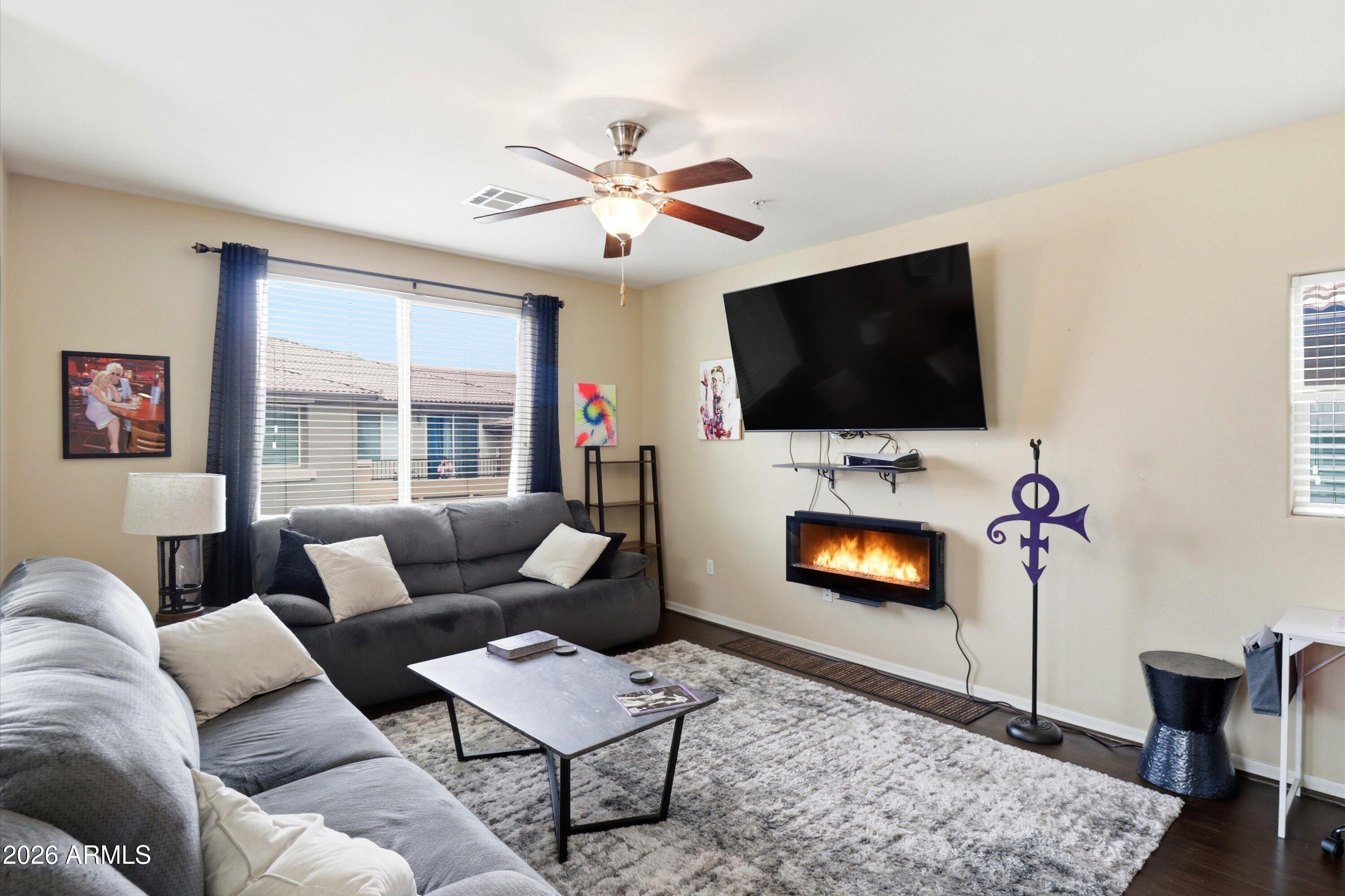 7726 East Baseline Road, Unit 227 Mesa, AZ 85209 - Photo 6 of 22 a living room with furniture and a flat screen tv