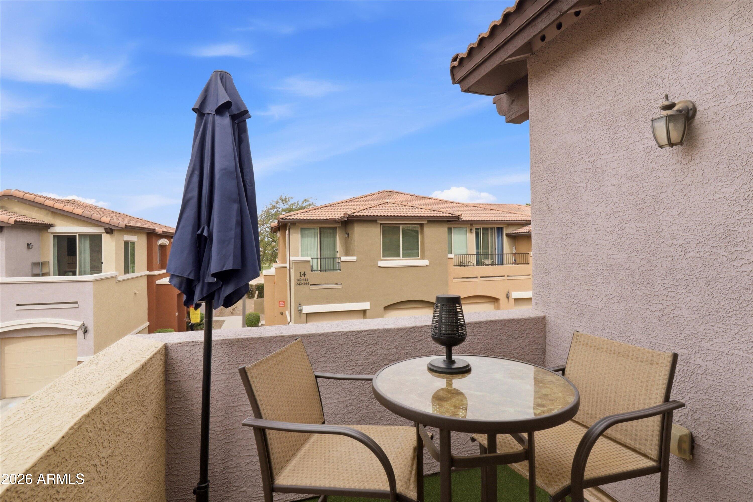 7726 East Baseline Road, Unit 227 Mesa, AZ 85209 - Photo 9 of 22 a balcony with table and chairs