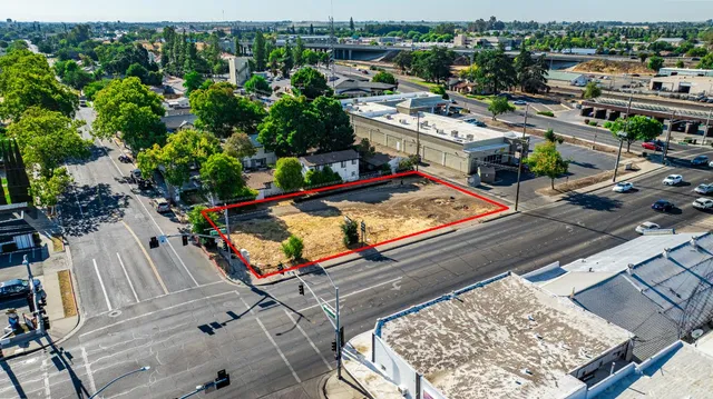 an aerial view of a tennis ground with a large tree