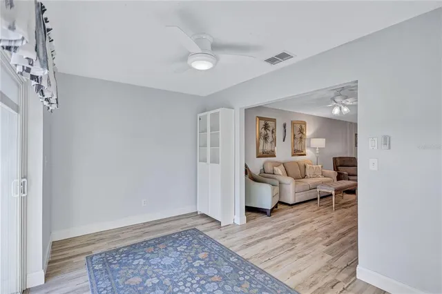 a view of a living room hardwood floor and a kitchen