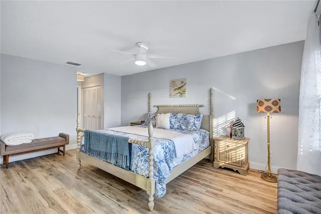 a bedroom with a large bed and a window