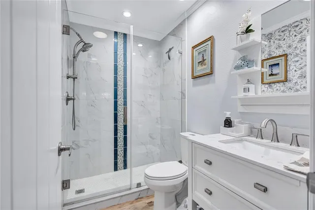 a bathroom with a sink vanity and toilet