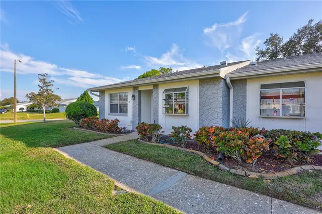 an aerial view of a house with garden space and ocean view