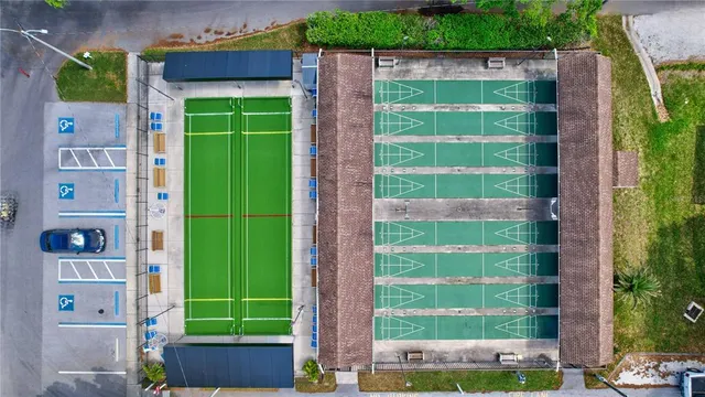 an aerial view of a house with garden space and street view