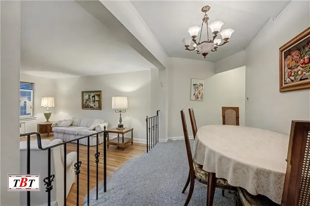 a view of a dining room with furniture and chandelier