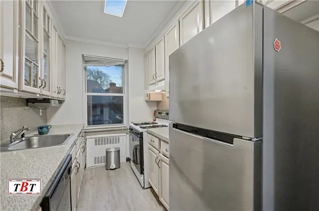 a kitchen with stainless steel appliances granite countertop a sink and cabinets