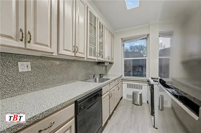 a kitchen with a sink stove and cabinets