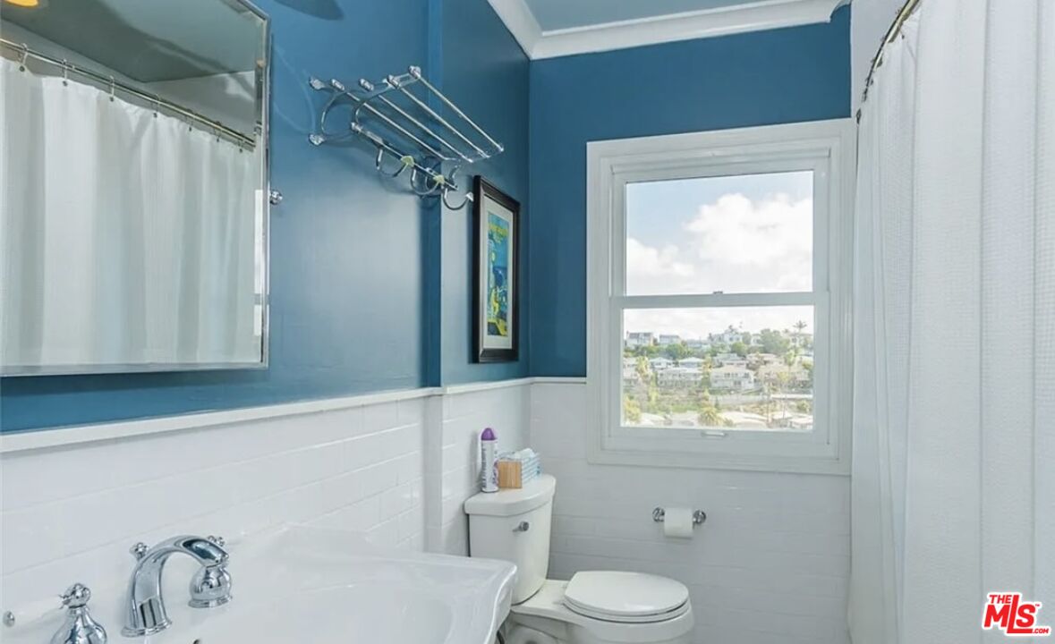 7032 Trask Avenue Playa del Rey, CA 90293 - Photo 14 of 35 a bathroom with a toilet a sink and a window