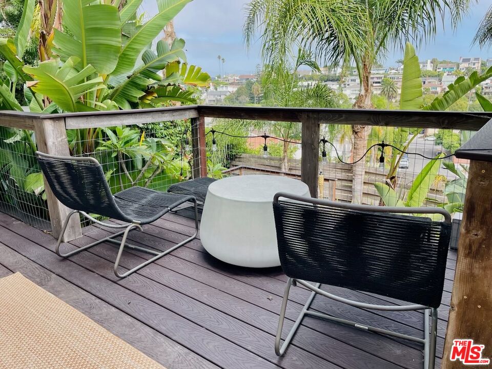 7032 Trask Avenue Playa del Rey, CA 90293 - Photo 18 of 35 a wooden bench sitting in front of a building