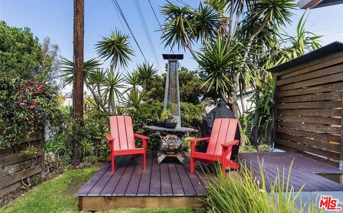 7032 Trask Avenue Playa del Rey, CA 90293 - Photo 27 of 35 a wooden bench sitting in a backyard with potted plants