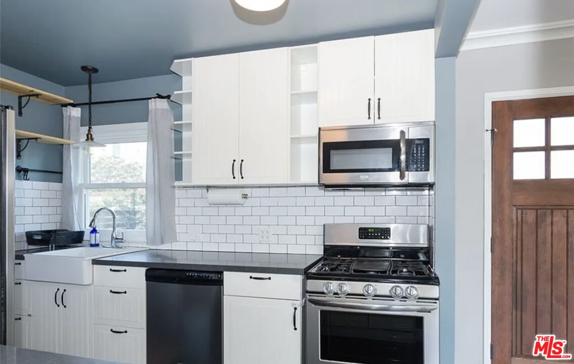 7032 Trask Avenue Playa del Rey, CA 90293 - Photo 8 of 35 a kitchen with stainless steel appliances a stove a sink and a microwave