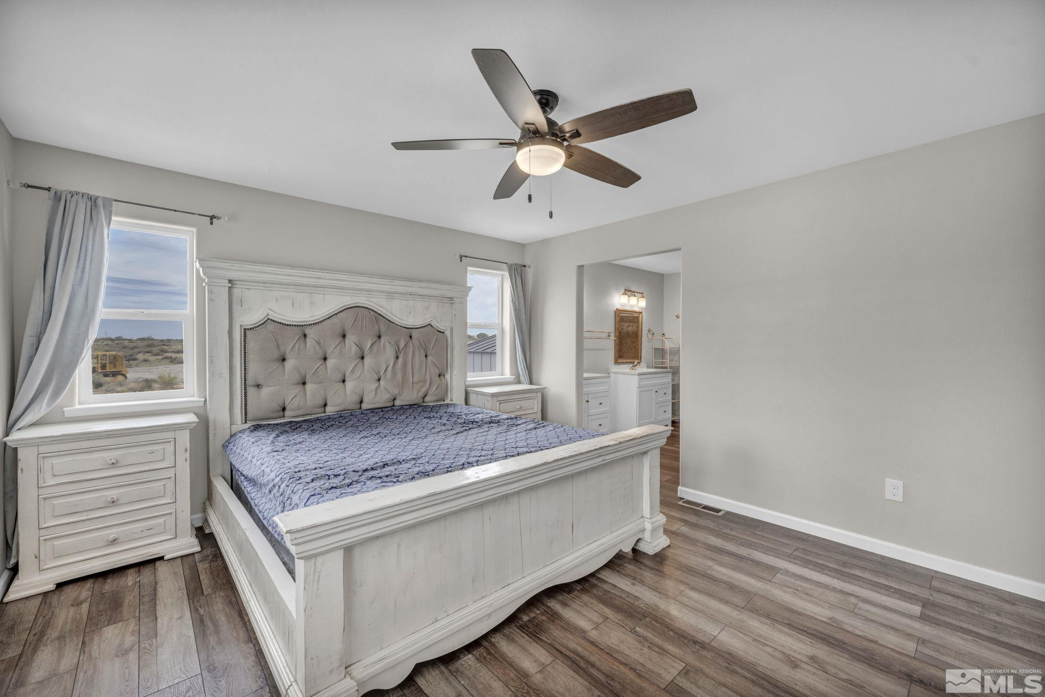 7330 Sandhill Road Fallon, NV 89406 - Photo 14 of 39 a living room with a bed and wooden floor