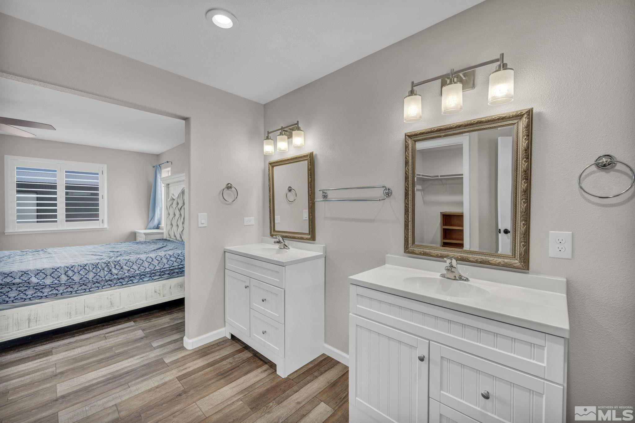 7330 Sandhill Road Fallon, NV 89406 - Photo 16 of 39 a en suite bathroom with a double vanity sink and a mirror