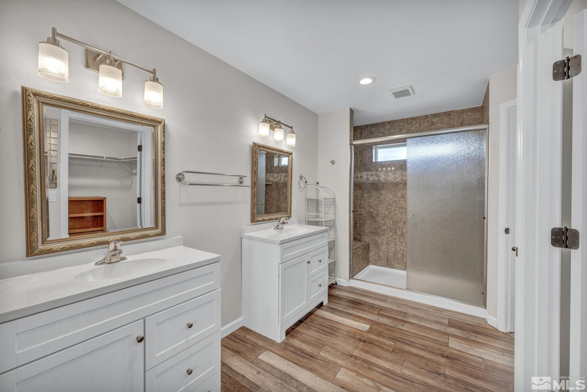 7330 Sandhill Road Fallon, NV 89406 - Photo 17 of 39 a bathroom with a double vanity sink mirror and shower