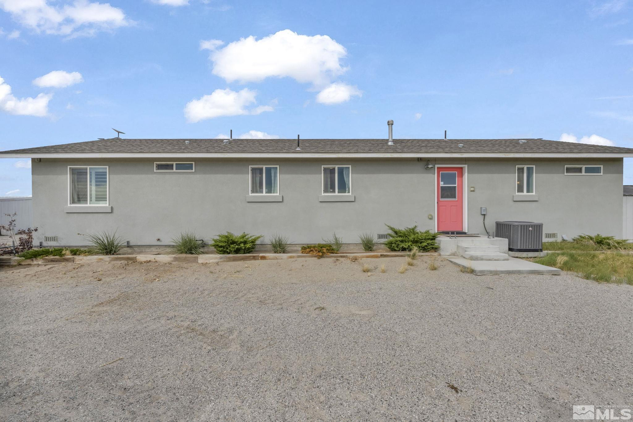 7330 Sandhill Road Fallon, NV 89406 - Photo 33 of 39 a front view of a house with a yard and garage