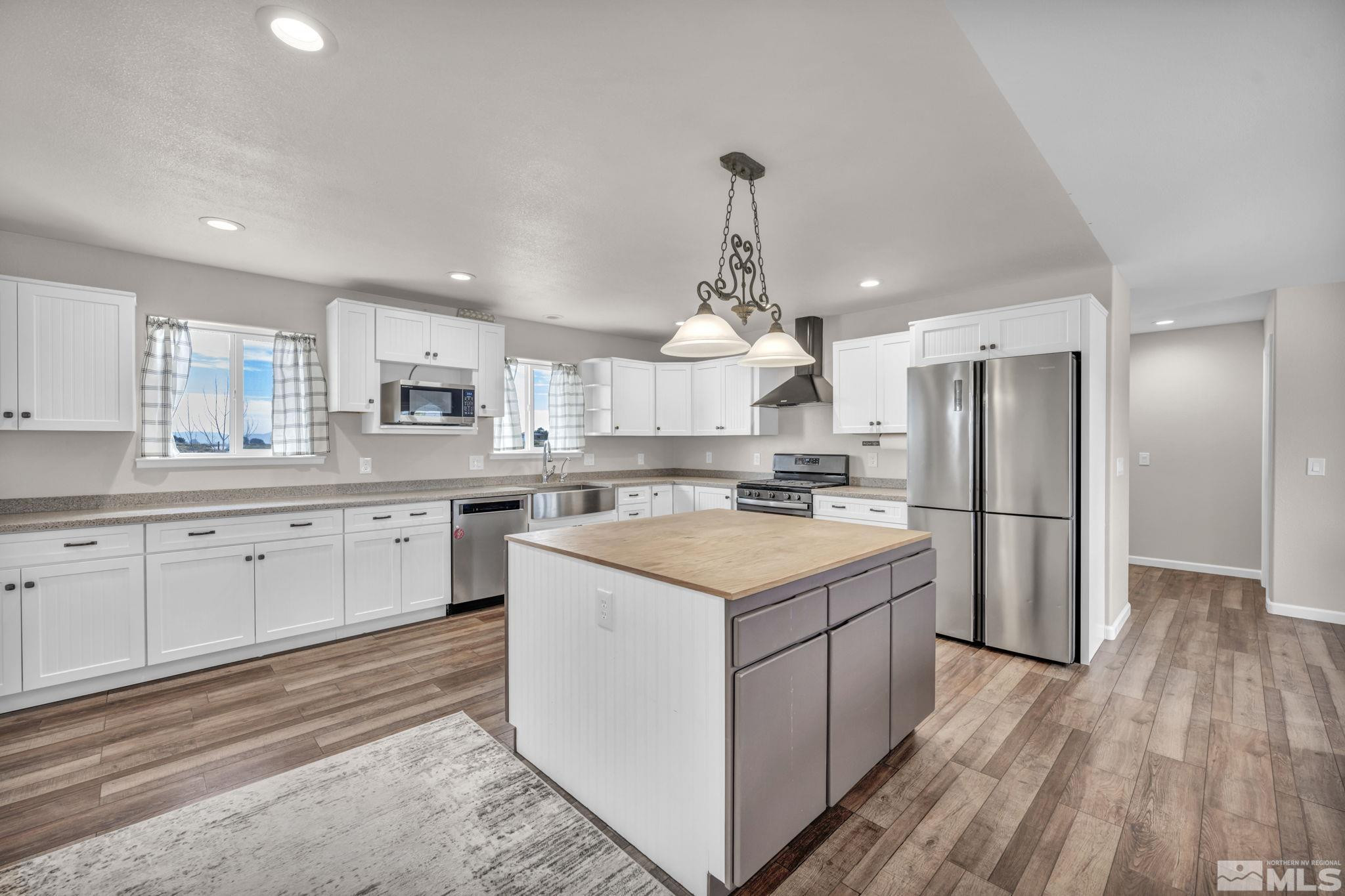 7330 Sandhill Road Fallon, NV 89406 - Photo 5 of 39 a kitchen with a sink refrigerator and cabinets