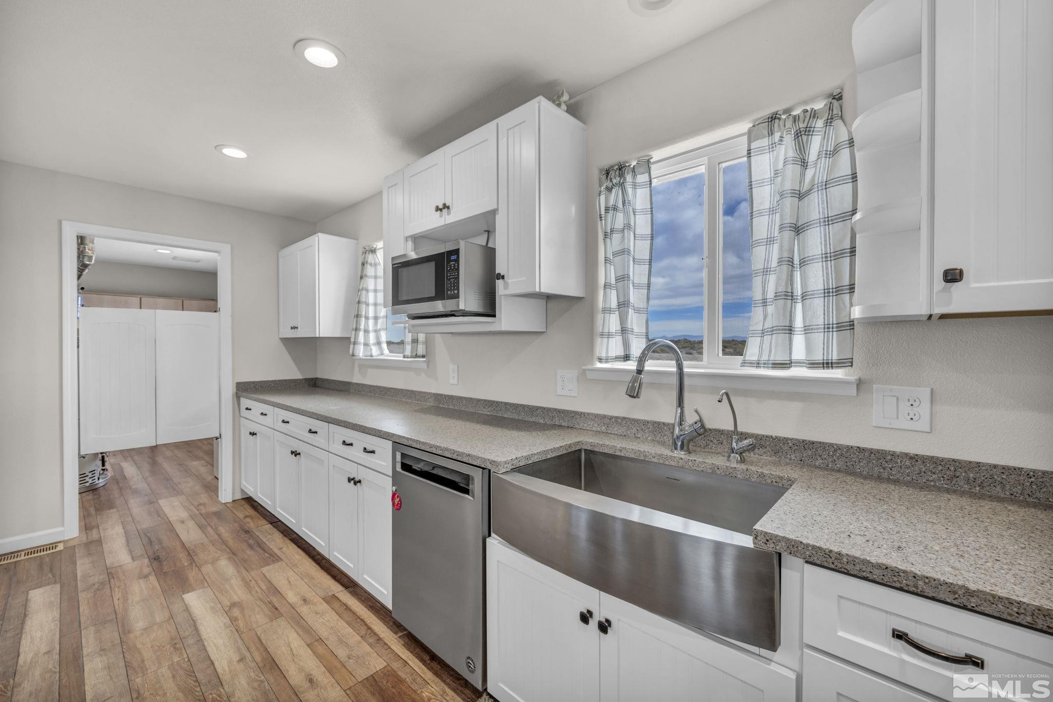 7330 Sandhill Road Fallon, NV 89406 - Photo 9 of 39 a kitchen with granite countertop a sink stainless steel appliances and cabinets