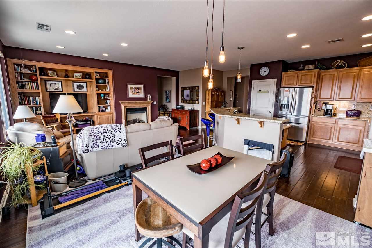 1295 Tarleton Way Reno, NV 89523 - Photo 9 of 23 a living room with stainless steel appliances kitchen island granite countertop furniture and a dining table with wooden floor
