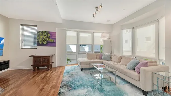 a living room with furniture and kitchen view