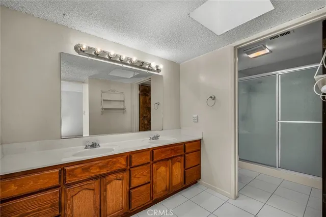 a bathroom with a double vanity sink and a mirror
