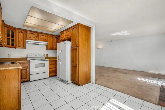 a kitchen with a stove top oven and cabinets