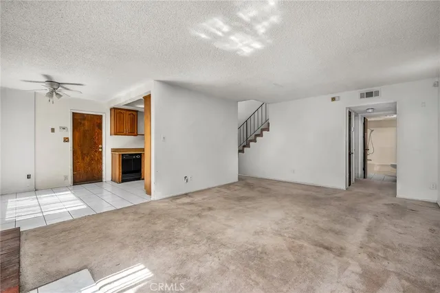 a view of an empty room with a fireplace