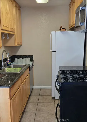 a kitchen with sink stove and cabinets