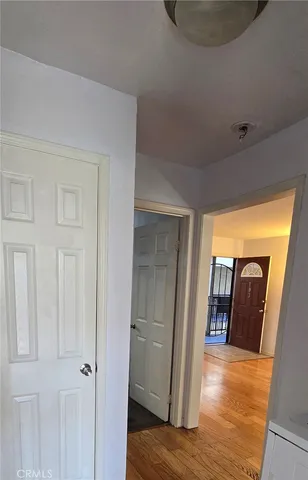 a view of hallway with wooden floor