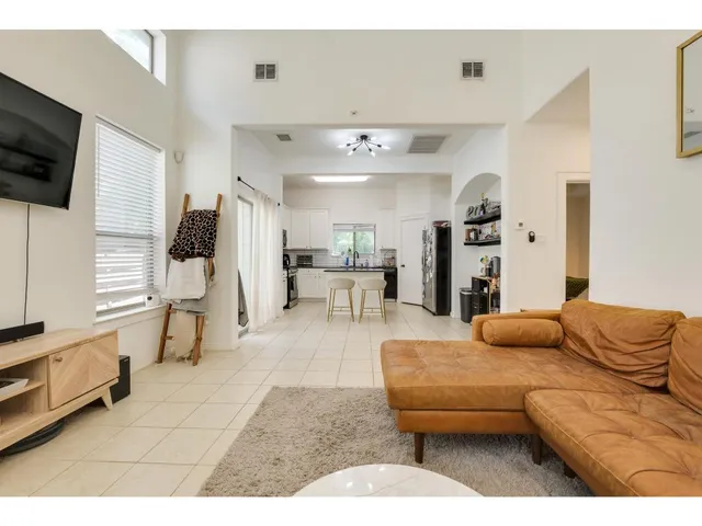 a kitchen with stainless steel appliances kitchen island granite countertop a refrigerator and a stove top oven
