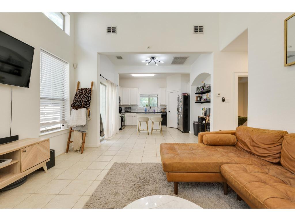 2001 Faro Drive, Unit 53 Austin, TX 78741 - Photo 11 of 34 a living room with furniture and a flat screen tv