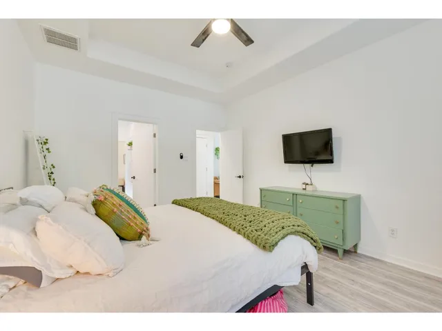 a bedroom with a bed and a flat screen tv